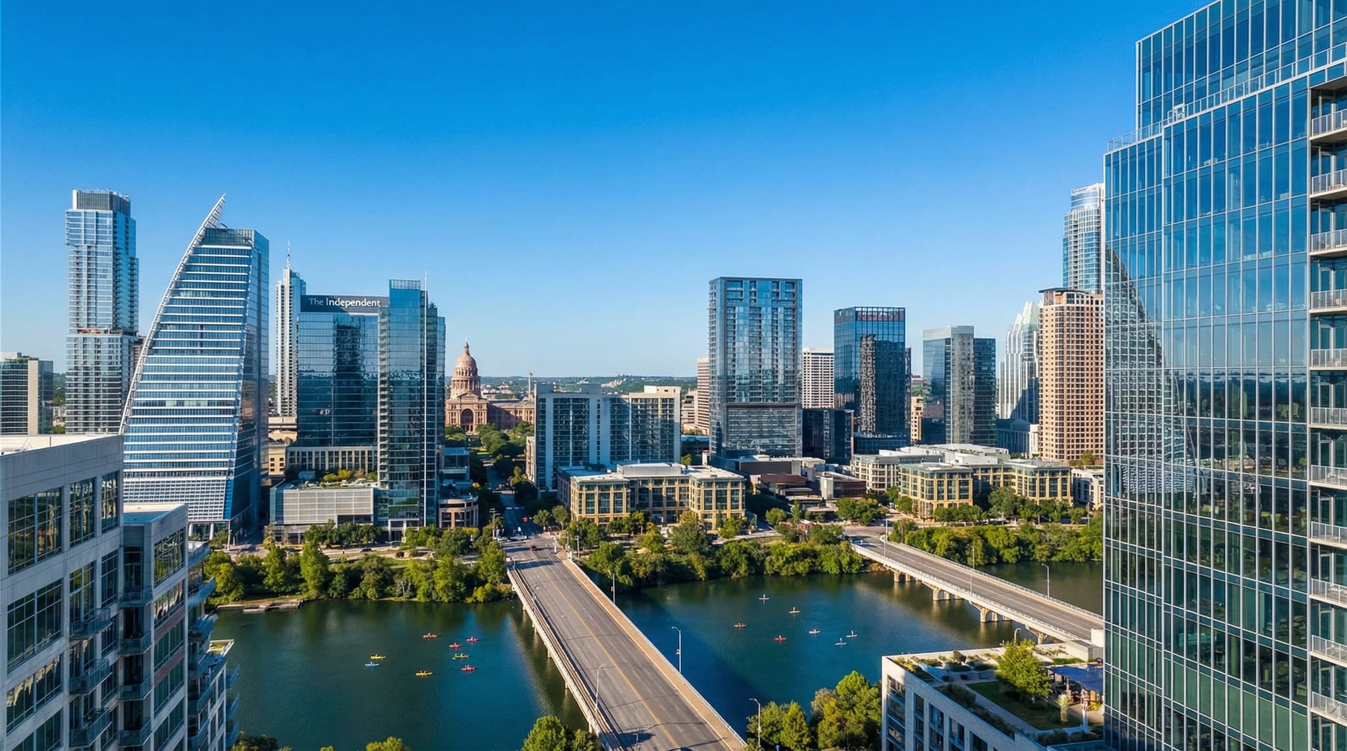 Austin Texas downtown skyline with Lady Bird Lake, Congress Avenue Bridge, and Texas State Capitol at twilight