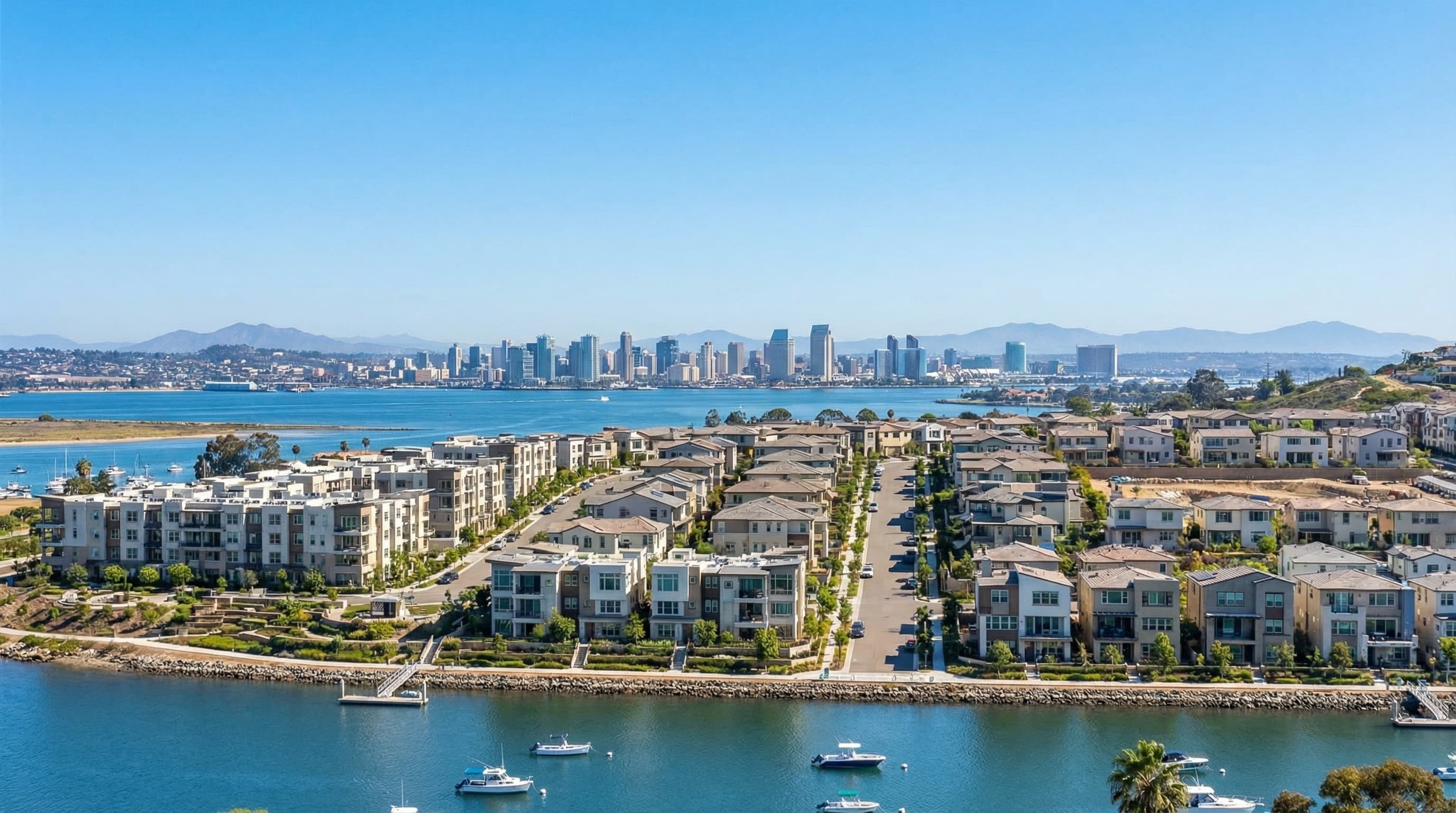 Growing Chula Vista California with San Diego Bay views, modern homes and developments, with downtown San Diego skyline visible in the distance