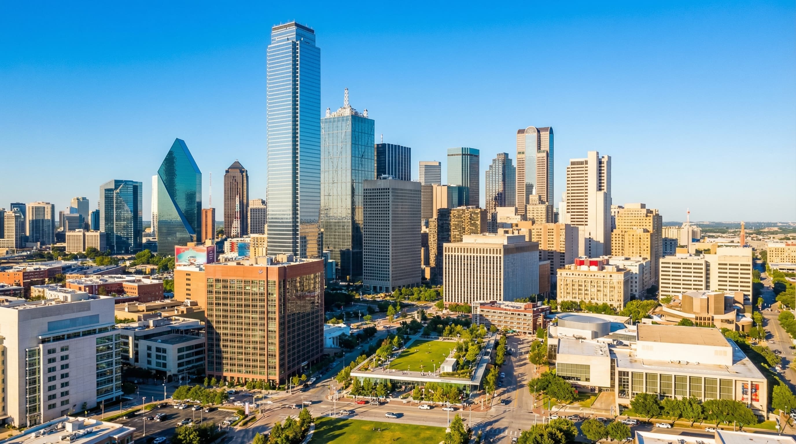 Dallas Texas downtown skyline with Reunion Tower, Arts District, and Uptown high-rises at twilight