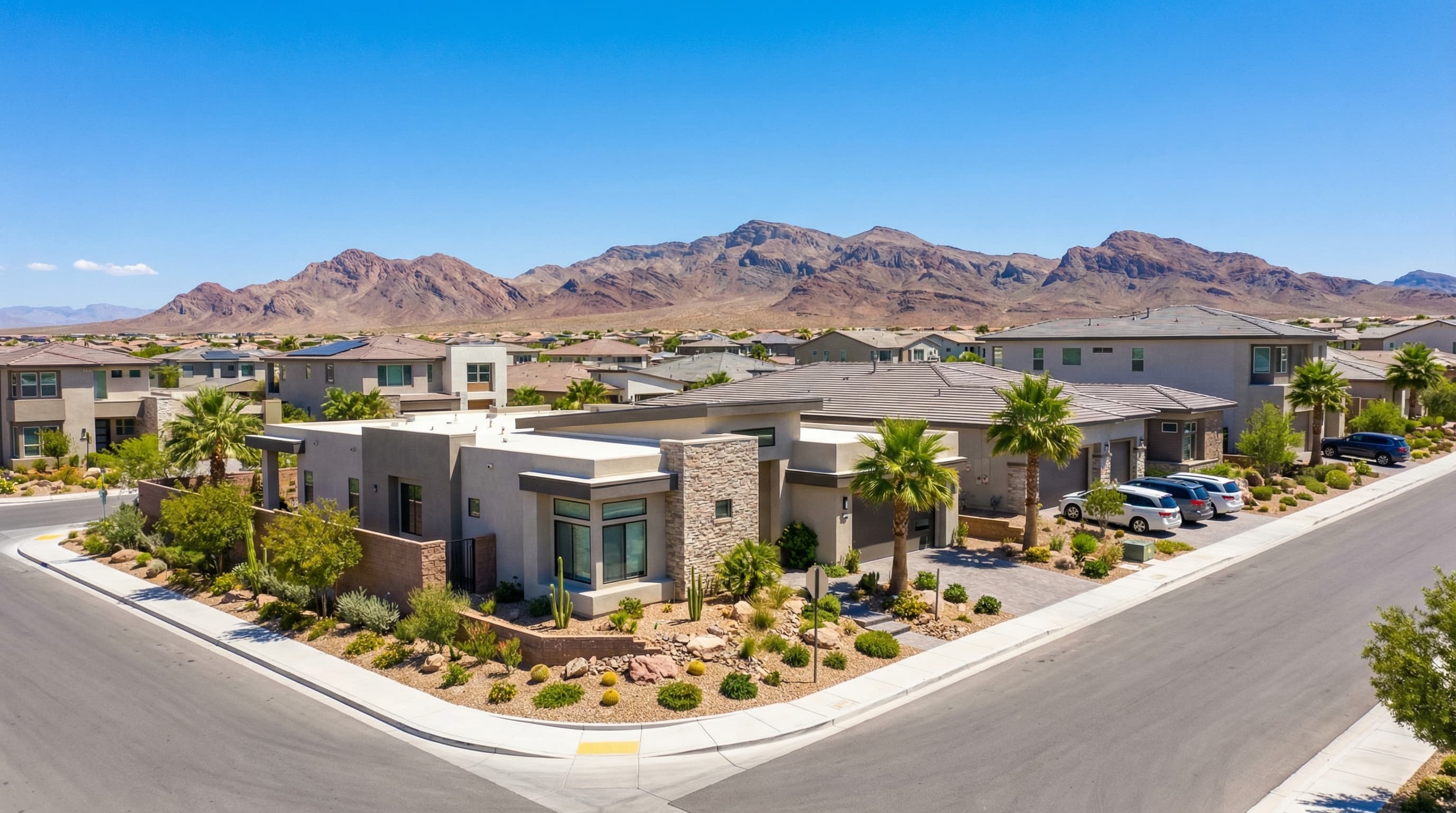 Henderson Nevada upscale master-planned community with Mediterranean-style homes, desert landscaping, and scenic mountain views under clear blue sky