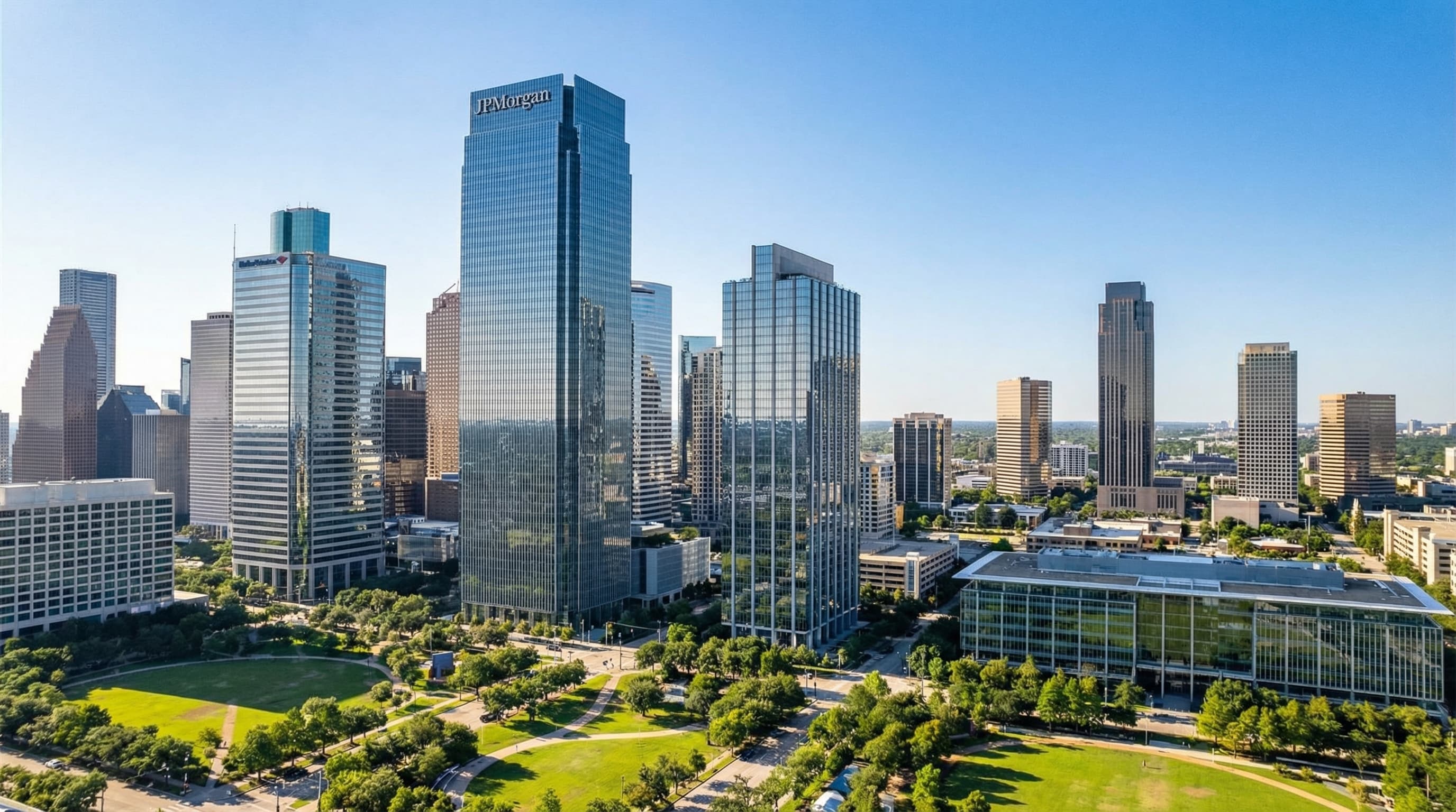 Houston Texas downtown skyline with Buffalo Bayou Park, Discovery Green, and Memorial Park at sunset