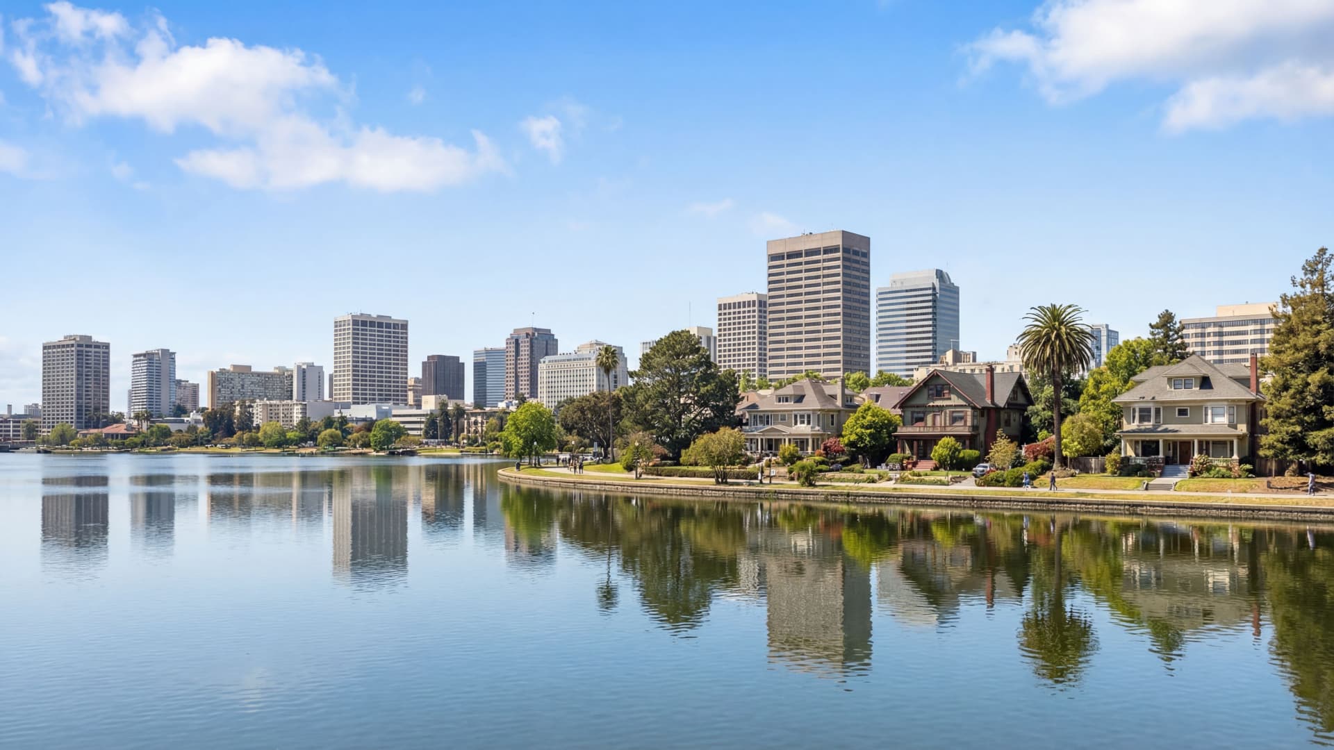 Lake Merritt view with downtown Oakland skyline and craftsman homes along shoreline